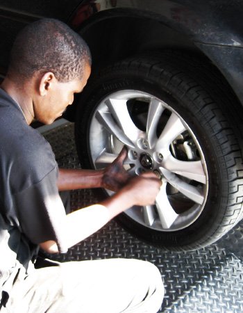 A Tiger Wheel & Tyre technician performing a tyre rotation